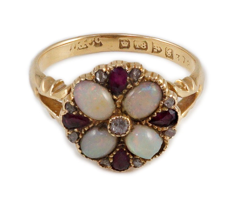 An Edwardian 18ct gold, ruby, white opal and diamond set circular cluster dress ring